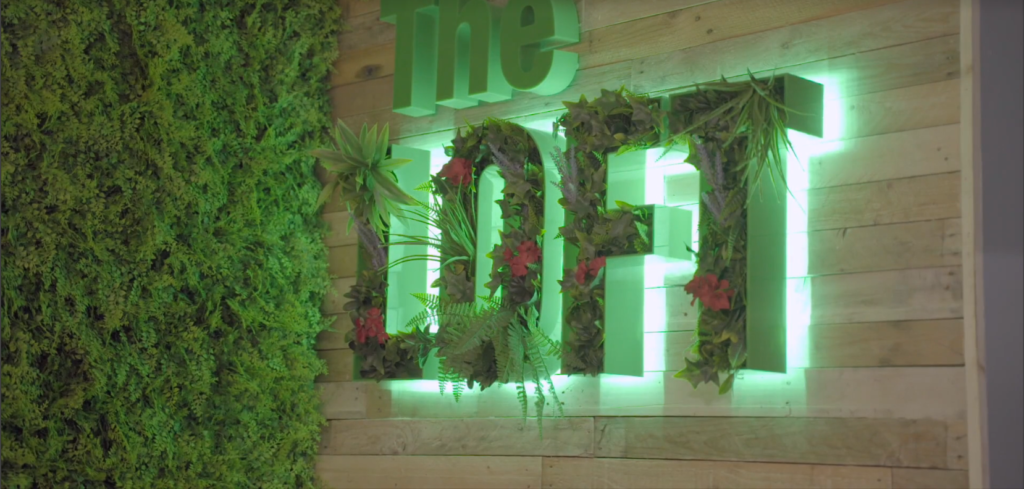 green neon loft sign with foliage